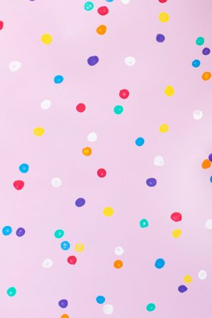Pink background with colorful dots
