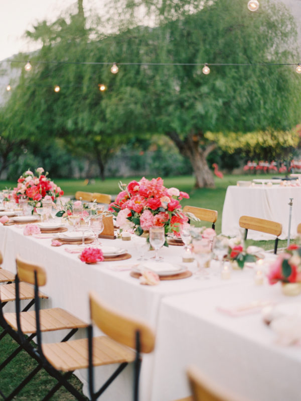 A table with flowers and chairs