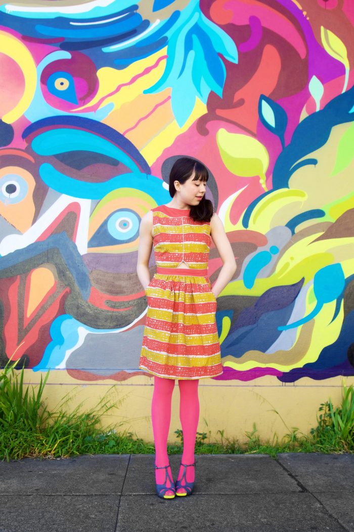 Someone standing in front of a colorful wall