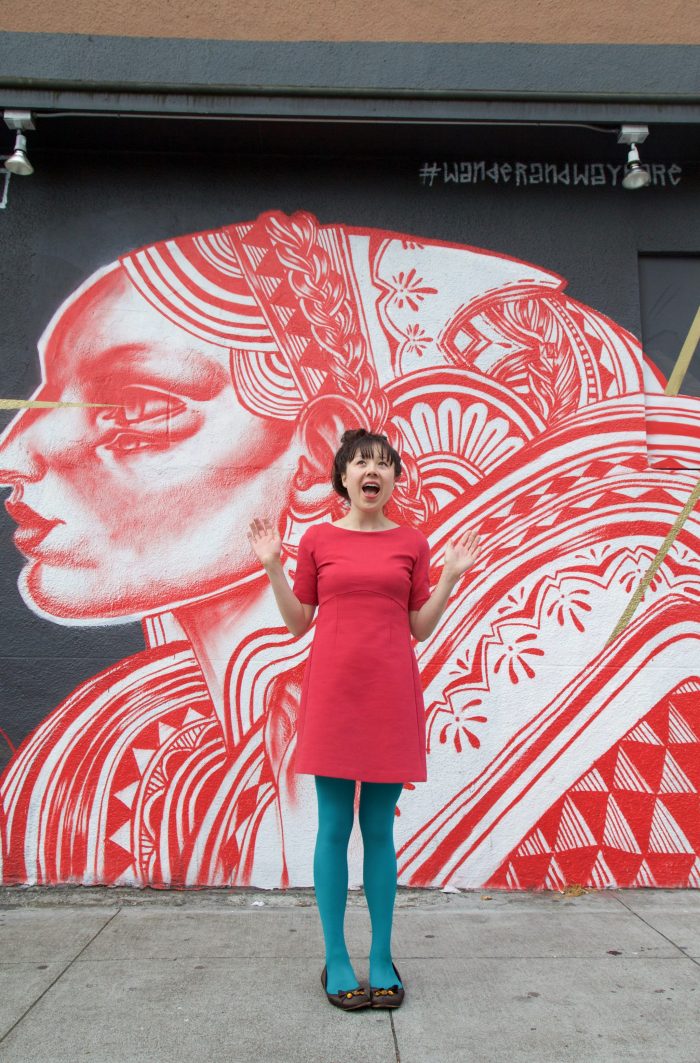 Someone standing in front of a mural