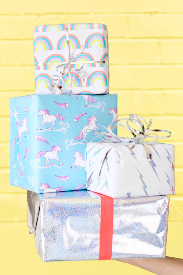 Colorful presents in front of a yellow wall