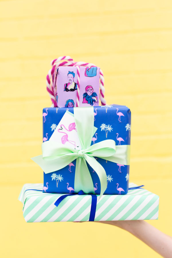 Colorful presents in front of a yellow wall