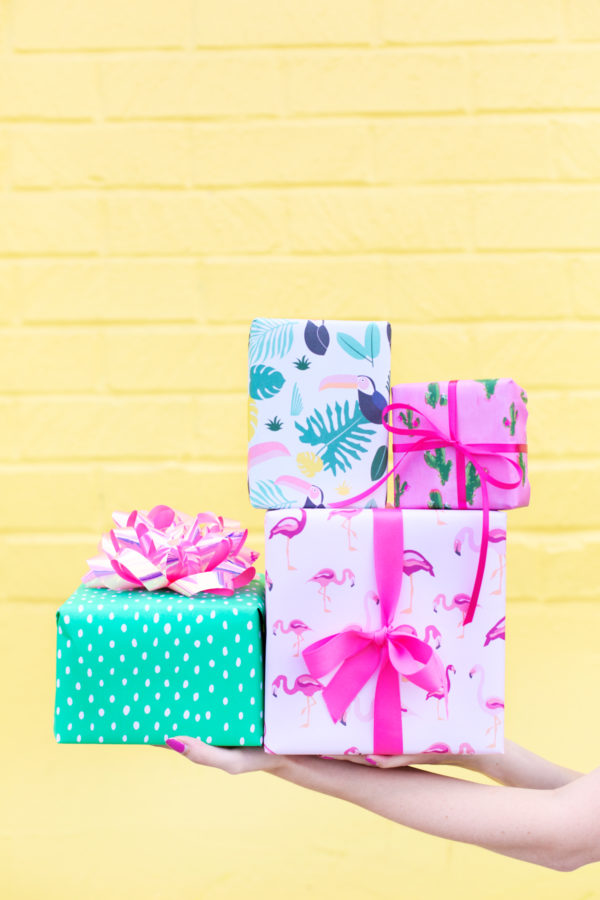 Colorful presents in front of a yellow wall