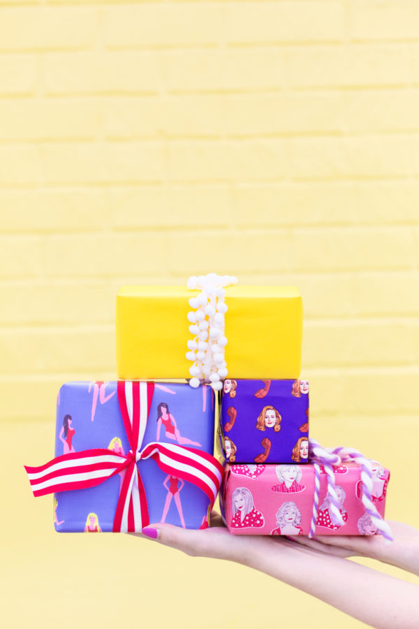 Colorful gifts in front of a yellow wall