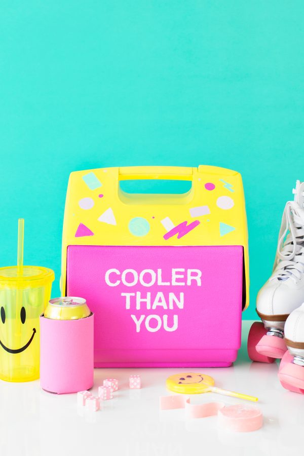 A pink and yellow cooler that says \"cooler than you\"