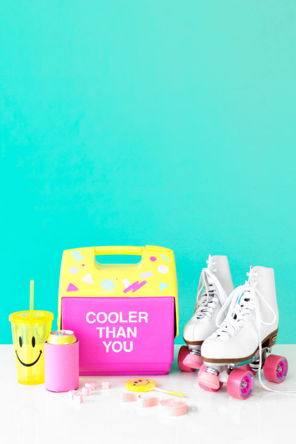 A pink and yellow cooler that says \"cooler than you\"