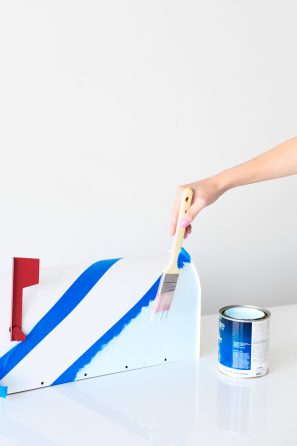 Someone painting a mailbox