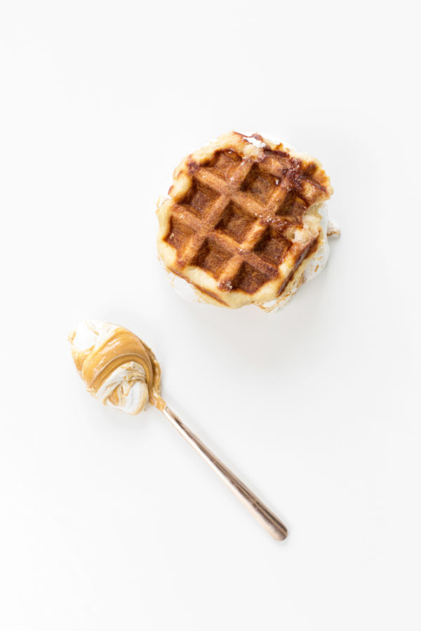 A waffle and a spoon with food