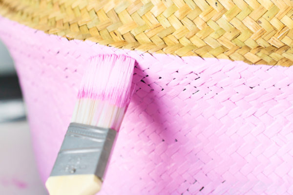 Paint brush and pink laundry basket