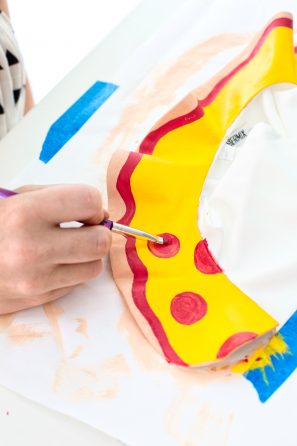 Someone painting pizza on a collar