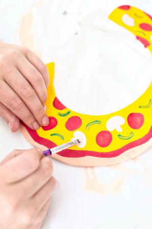 Someone painting pizza on a collar