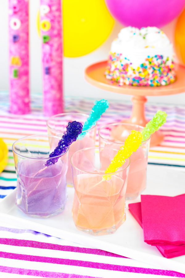 Glasses with a drink in it and colorful sticks