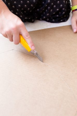 Someone cutting cardboard