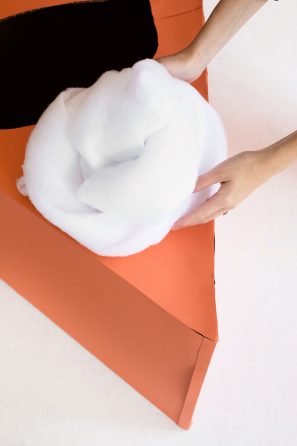 Cotton ball on orange cardboard 