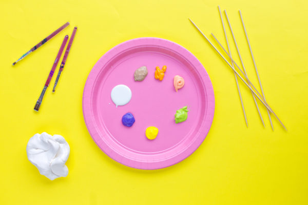 A pink plate with paint on it