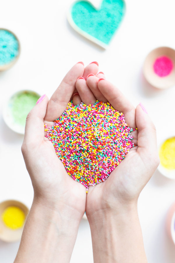 Someone holding sprinkles in their hands