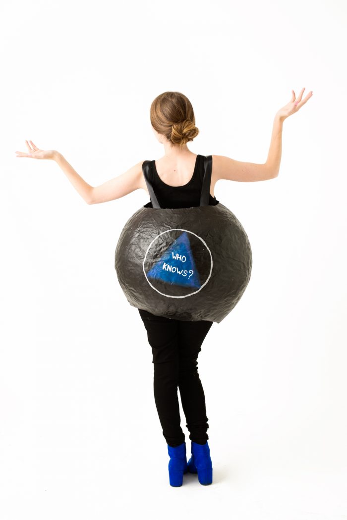A woman wearing an eight ball costume 