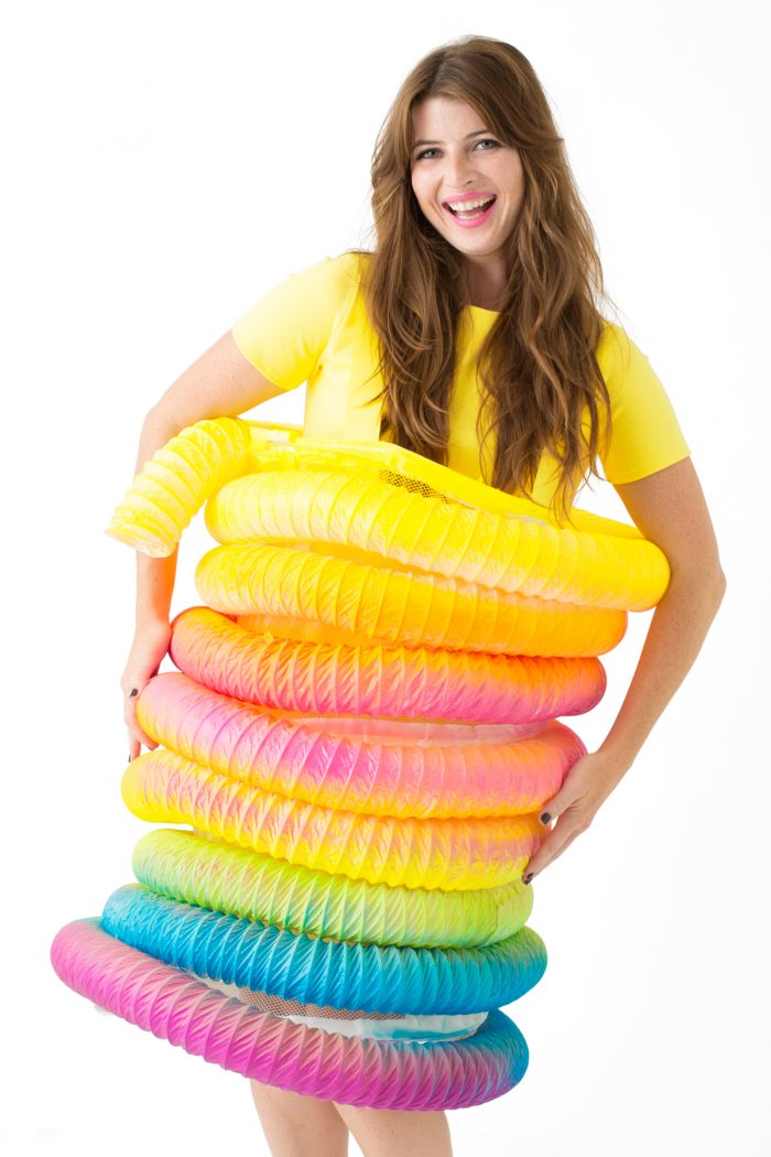 A woman dressed in a rainbow toy costume