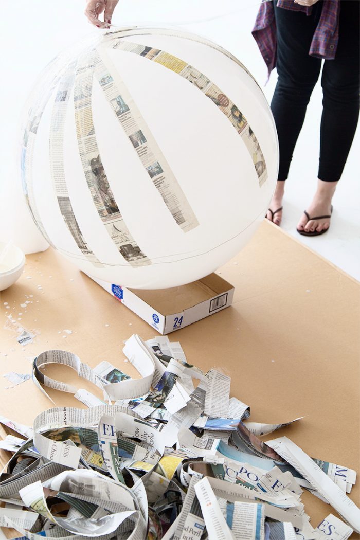 Ball with newspaper being glued onto it