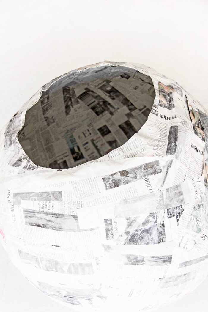 A ball with newspapers glued on it