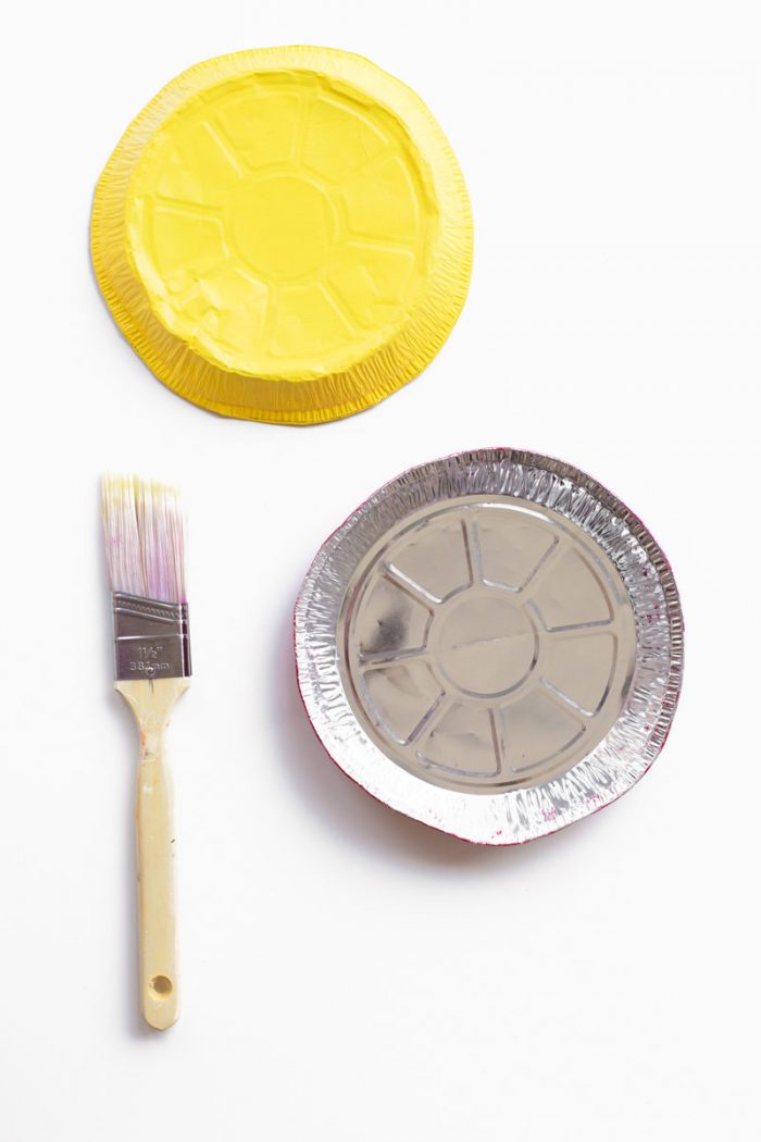 A tin tray and paint brush.