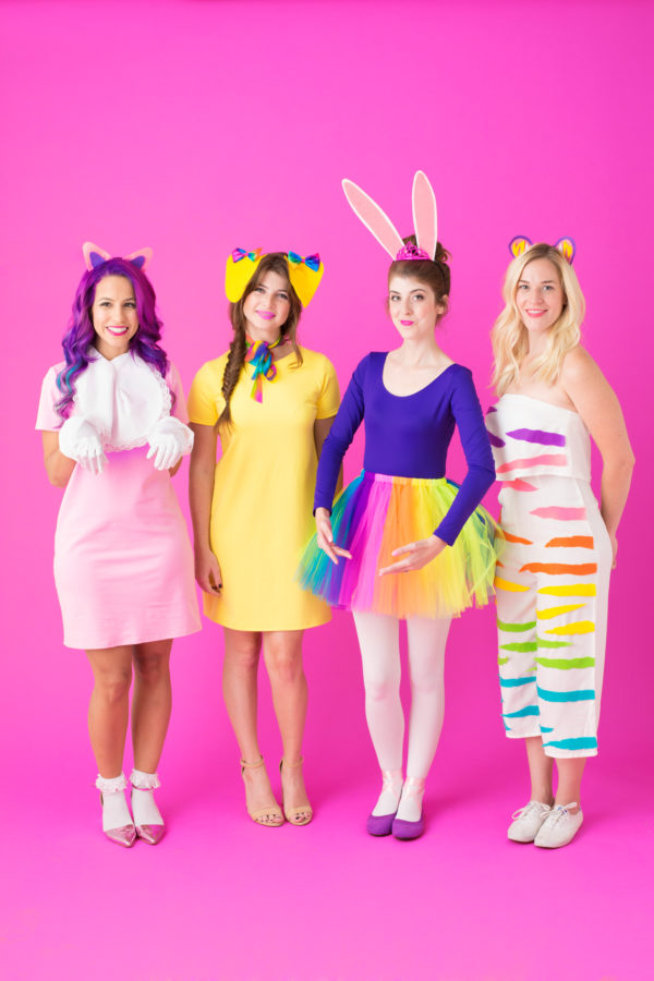 A group of people posing for the camera in colorful costumes 