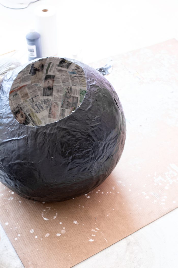 A newspaper ball painted black