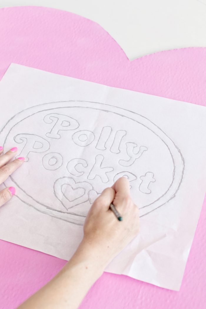 Someone writing "polly pocket" on a paper