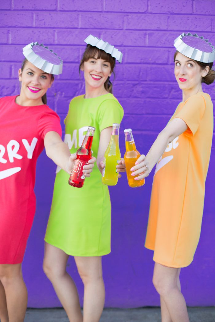 Three woman in soda bottle costumes
