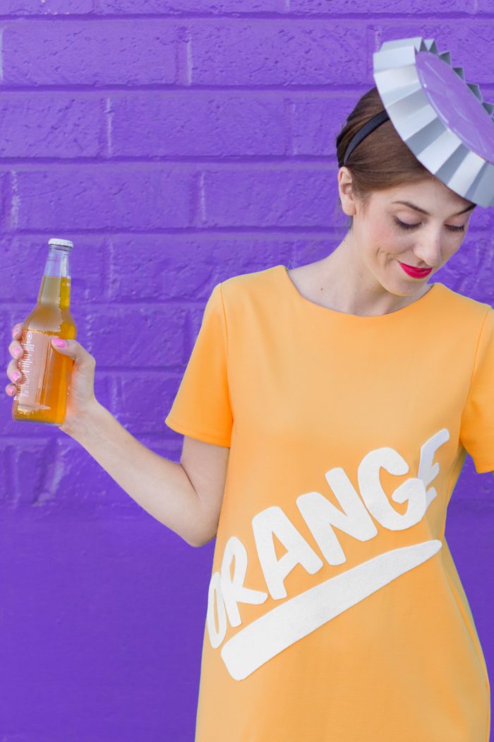 A woman in an orange soda costume