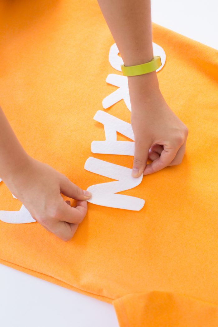 White-letter cut-outs on orange fabric