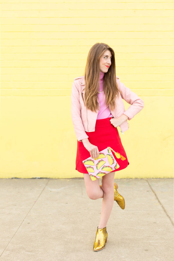 A woman holding a taco clutch 