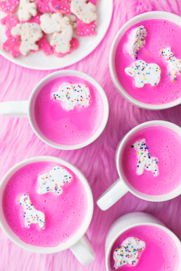 Mugs with pink drinks and animal cookie marshmallows in it