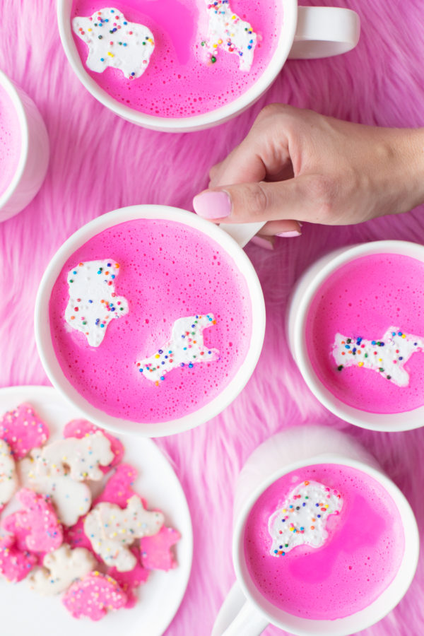 Mugs with pink liquid and circus animal cookie marshmallows in them