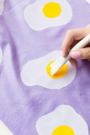 Purple fabric with egg painting on it