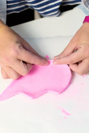 Someone playing with pink clay