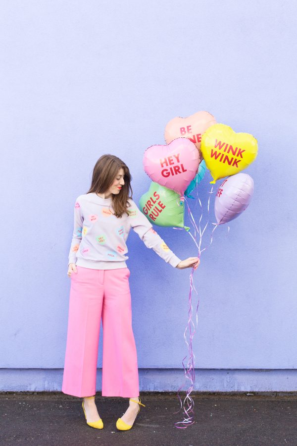 A woman holding balloons