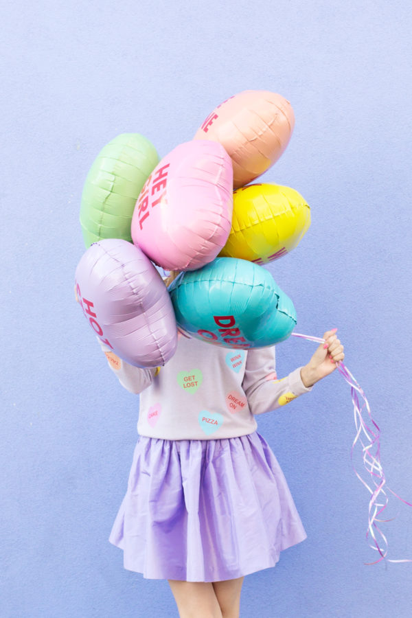 A woman holding balloons