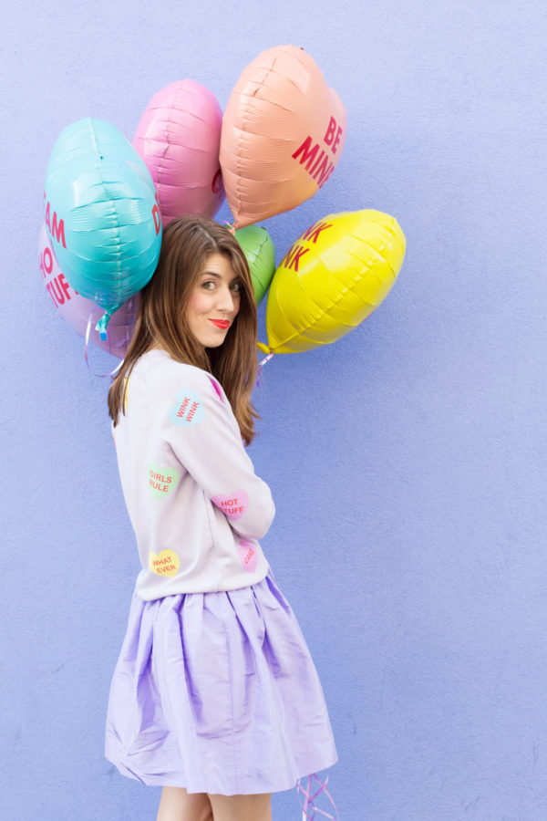 A woman holding colorful balloons
