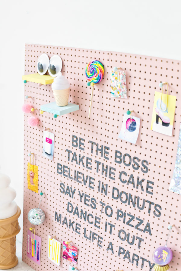 A pink wooden board with accessories on it