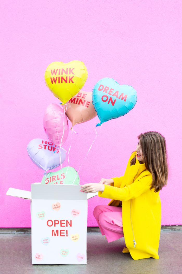 A woman opening a box of balloons