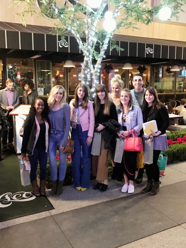 A group of people standing in front of a building