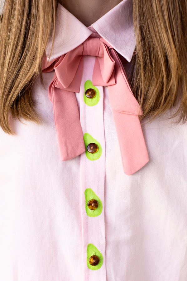 A close up of shirt with avocado buttons