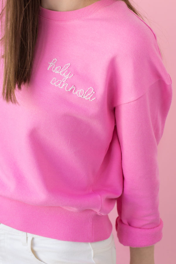 Holy cannoli embroidered on a pink crew neck