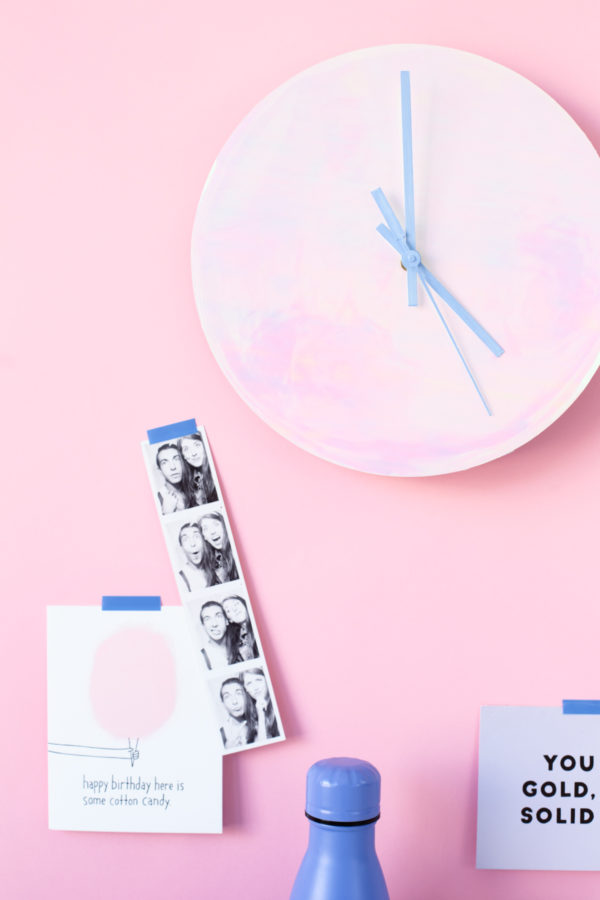 A pink clock and photobooth images