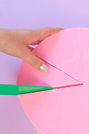 Someone cutting a slice of soap