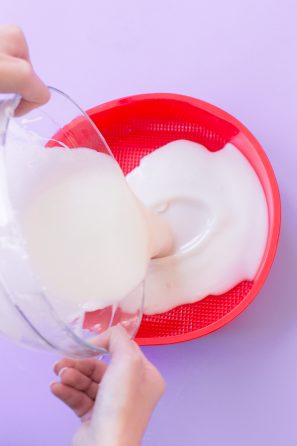 Someone pouring a substance into a bowl