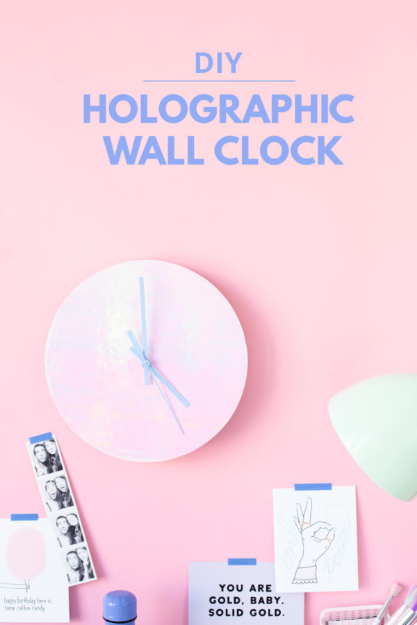 A holographic clock on a pink wall