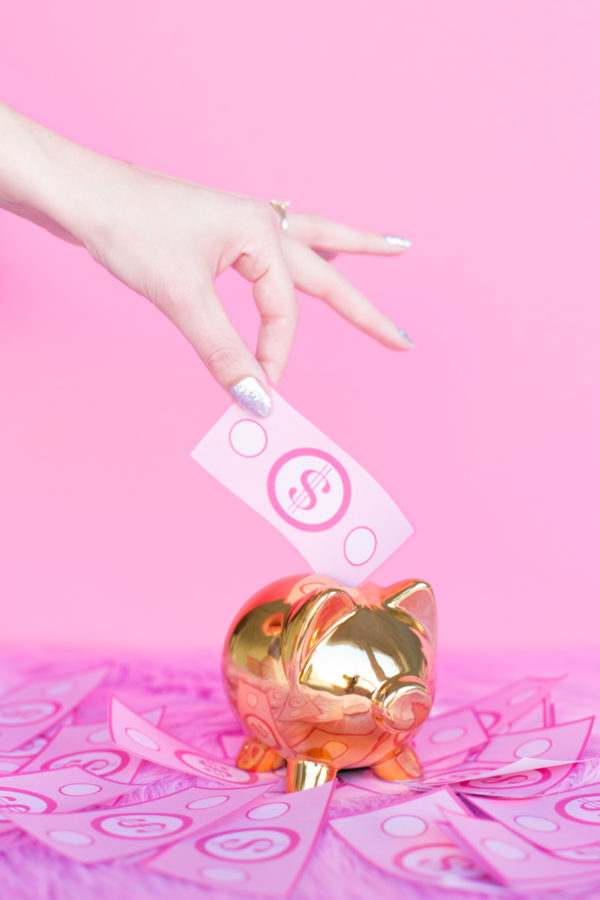 Golden piggy bank and pink money