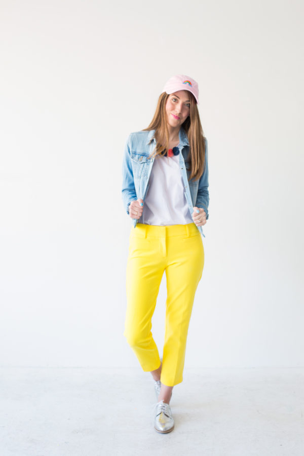 A woman wearing yellow pants and jean jacket